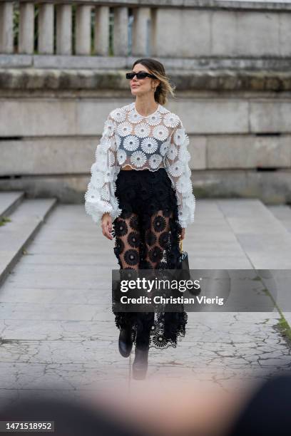 Martha Graeff wears white embroidered transparent blouse, skirt outside Elie Saab during Paris Fashion Week - Womenswear Fall Winter 2023 2024 : Day...