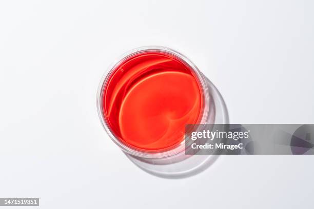 closed petri dish with red colored medium - oggetti dall'alto foto e immagini stock