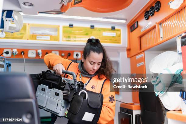 female paramedic working on an ambulance - accident hospital stock pictures, royalty-free photos & images