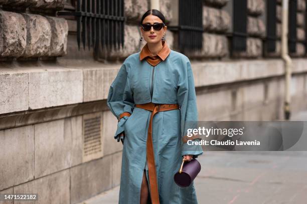 Julia Haghjoo wears a turquoise trench coat with tan details and pink heels, outside Hermes, during Paris Fashion Week - Womenswear Fall Winter 2023...