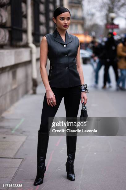 Kelsey Merritt wears a black leather Hermes vest, black leggings, black boots and black Hermes mini bag, outside Hermes, during Paris Fashion Week -...