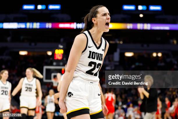 Caitlin Clark of the Iowa Hawkeyes celebrates her three-point basket against the Ohio State Buckeyes in the first half of the championship game of...