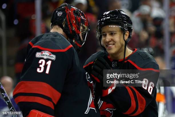 Frederik Andersen and Teuvo Teravainen of the Carolina Hurricanes celebrate their 6-0 victory over the Tampa Bay Lightning following the game at PNC...