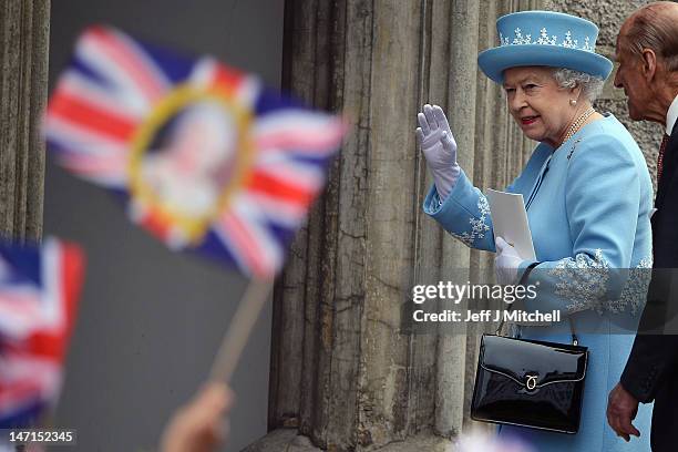 Queen Elizabeth II waves to wellwishers a she and Prince Philip, Duke of Edinburgh visit Macartin's Cathedral on June 26, 2012 in Enniskillen,...