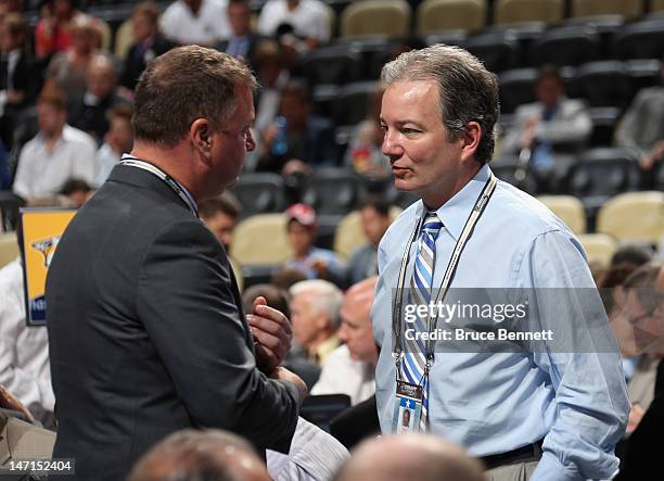 Mike Gillis of the Vancouver Canucks and Ray Shero of the Pittsburgh Penguins discuss matters during Round One of the 2012 NHL Entry Draft at Consol...