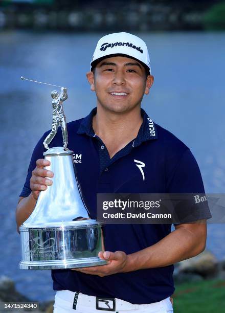 Kurt Kitayama of The United States holds the trophy after his one-shot win in the final round of the Arnold Palmer Invitational presented by...