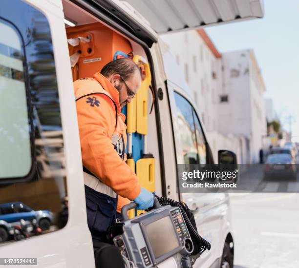 paramedic getting out of an ambulance to attend to an emergency - accident hospital stock pictures, royalty-free photos & images
