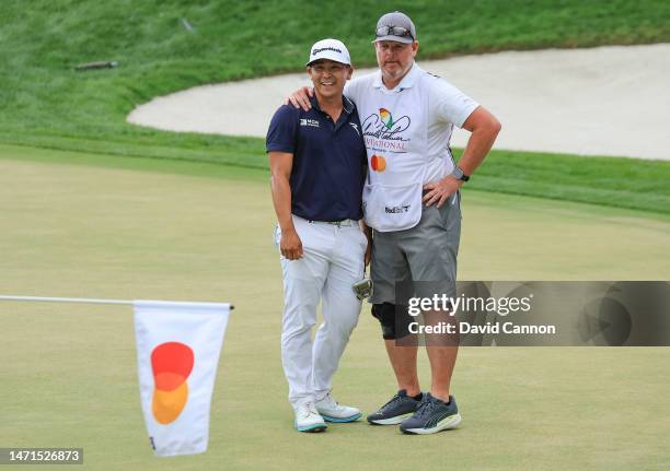 Kurt Kitayama of The United States and his caddie Tim Tucker embrace after he secured his one shot win on the 18th green during the final round of...