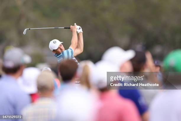 Jordan Spieth of the United States plays his shot from the 14th tee as fans look on during the final round of the Arnold Palmer Invitational...