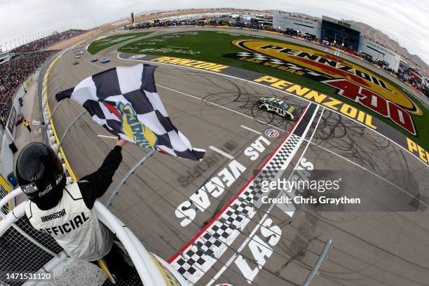 William Byron, driver of the RaptorTough.com Chevrolet, takes the checkered flag to win the NASCAR Cup Series Pennzoil 400 at Las Vegas Motor...