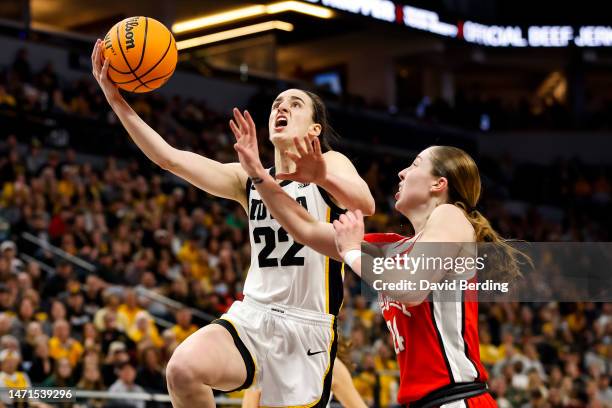 Caitlin Clark of the Iowa Hawkeyes is fouled by Taylor Mikesell of the Ohio State Buckeyes in the second half of the championship game of the Big Ten...