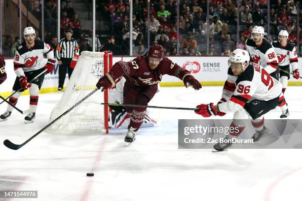 Lawson Crouse of the Arizona Coyotes skates for a loose puck agianst Timo Meier of the New Jersey Devils in the second period at Mullett Arena on...