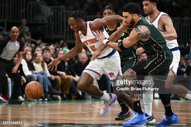 Immanuel Quickley of the New York Knicks and Jayson Tatum of the Boston Celtics race for a loose ball during the first quarter at the TD Garden on...