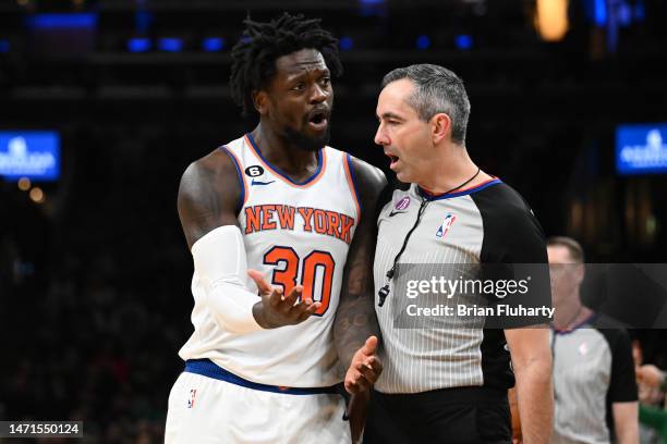 Julius Randle of the New York Knicks bumps into referee Brett Nansel drawing a technical foul during the third quarter of a game against the Boston...