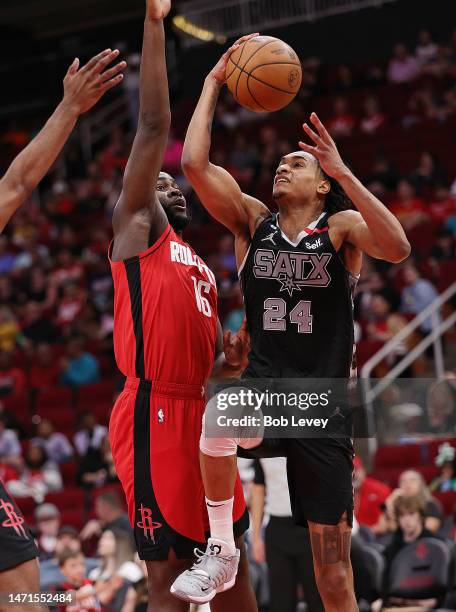 Khem Birch of the San Antonio Spurs drives to the basket against Usman Garuba of the Houston Rockets at Toyota Center on March 05, 2023 in Houston,...