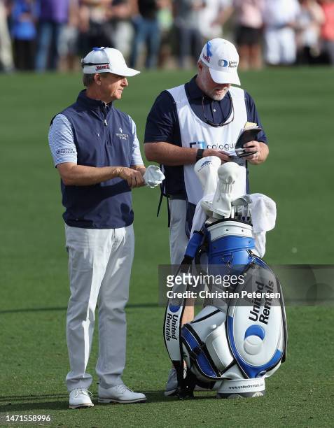 David Toms of the United States stands with his caddie and bag on the 18th hole during the final round of the Cologuard Classic at Omni Tucson...