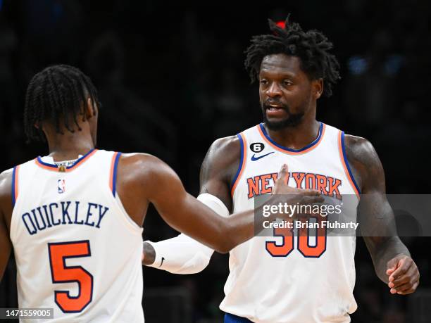 Immanuel Quickley of the New York Knicks high-fives Julius Randle during overtime against the Boston Celtics at the TD Garden on March 05, 2023 in...