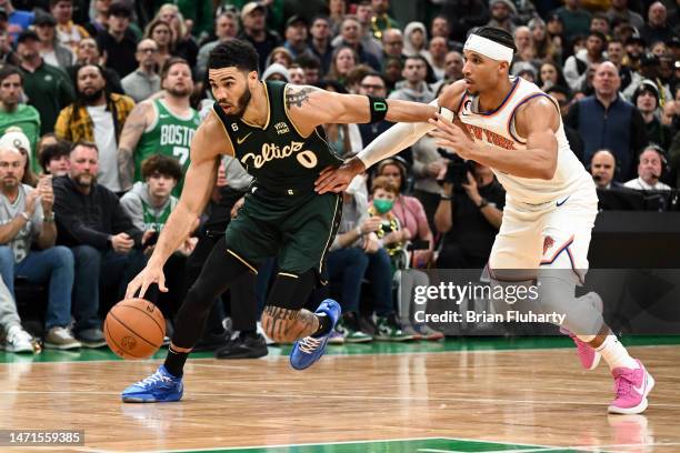 Jayson Tatum of the Boston Celtics drives to the basket against Trevor Keels of the New York Knicks during overtime at the TD Garden on March 05,...