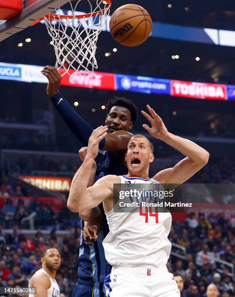 Mason Plumlee of the LA Clippers and Jaren Jackson Jr. #13 of the Memphis Grizzlies jump for a rebound in the first half at Crypto.com Arena on March...