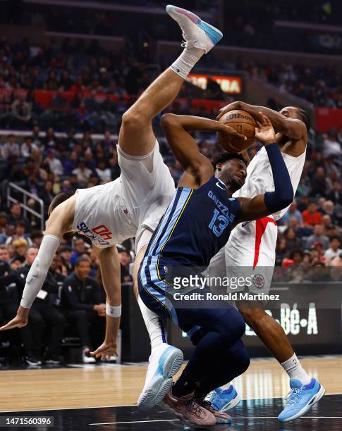 Ivica Zubac of the LA Clippers fouls Jaren Jackson Jr. #13 of the Memphis Grizzlies in the first half at Crypto.com Arena on March 05, 2023 in Los...