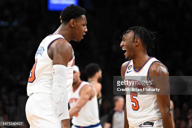 Immanuel Quickley of the New York Knicks reacts with RJ Barrett after scoring against the Boston Celtics during the fourth quarter at the TD Garden...
