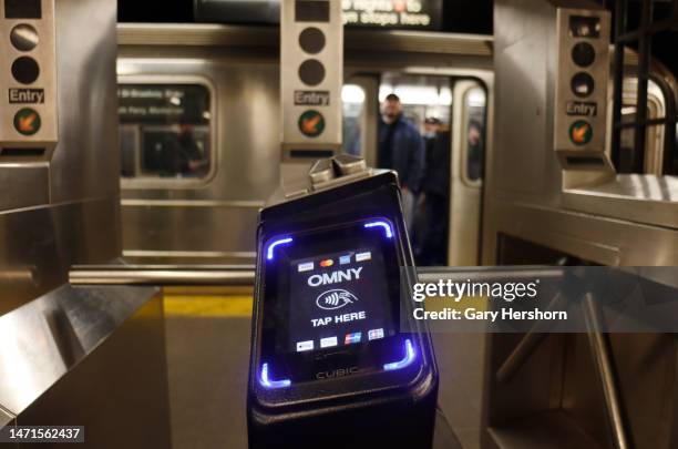 An OMNY fare reader is pictured in front of a '1 line train at the Christopher Street subway station on March 5 in New York City.