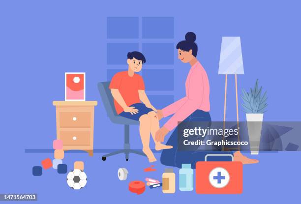 mother wounds son who fell while playing soccer using first aid kit - concerned parent stock illustrations