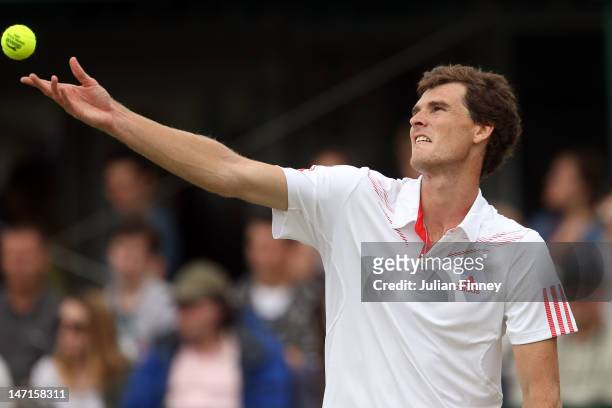 Jamie Murray of Great Britain serves while playing with Eric Butorac of the USA during their Gentlemen's Doubles first round match against Andre...