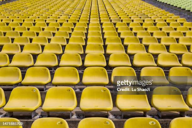 rows of yellow stadium seats - football background stock pictures, royalty-free photos & images