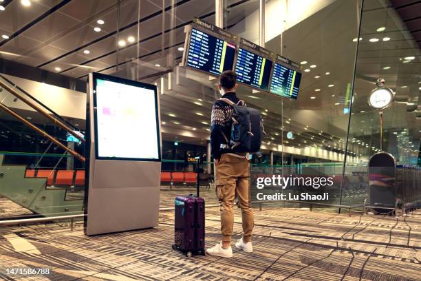 tourists in the airport terminal. - men-airport-fashion stock pictures, royalty-free photos & images