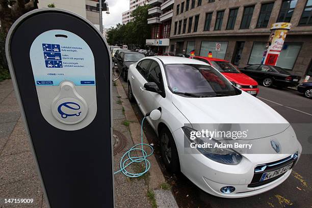 An electric Renault Fluence Z.E. Automobile sits plugged into an RWE electric car charging station on the street on June 26, 2012 in Berlin, Germany....