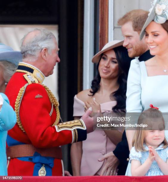 Prince Charles, Prince of Wales, Meghan, Duchess of Sussex and Prince Harry, Duke of Sussex stand on the balcony of Buckingham Palace during Trooping...