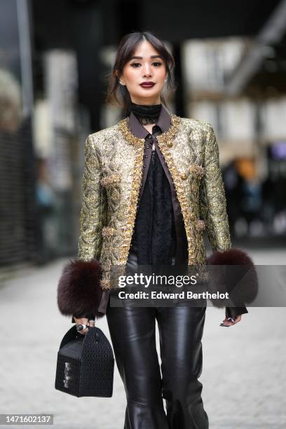 Heart Evangelista wears diamond earrings, a black lace print pattern tulle necklace / V-neck blouse shirt, a black with gold embroidered pattern /...