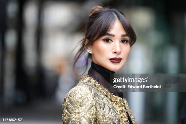 Heart Evangelista wears diamond earrings, a black lace print pattern tulle necklace / V-neck blouse shirt, a black with gold embroidered pattern /...