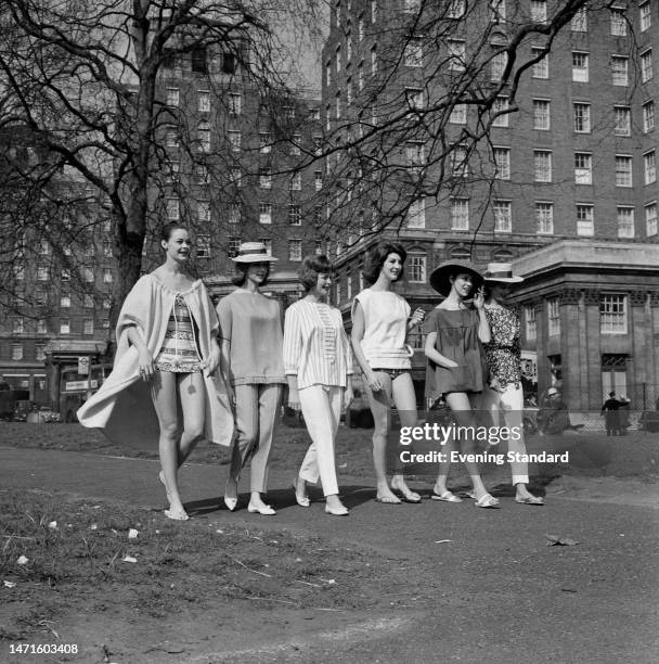 Models walk together in the garden in front of Grosvenor House Hotel for a fashion show, Park Lane, London, March 24th 1960.