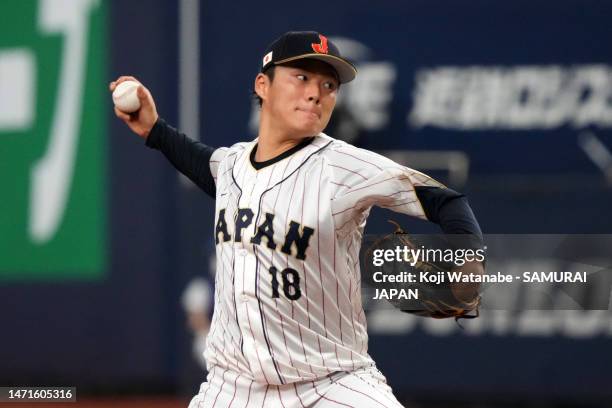Pitcher Yoshinobu Yamamoto of Japan throws in the first inning during the World Baseball Classic exhibition game between Japan and Hanshin Tigers at...