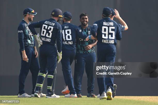 England bowler Rehan Ahmed is congratulated by team mates after having Bangladesh batsman Mehidy Hasan Miraz caught off his own bowling for his first...