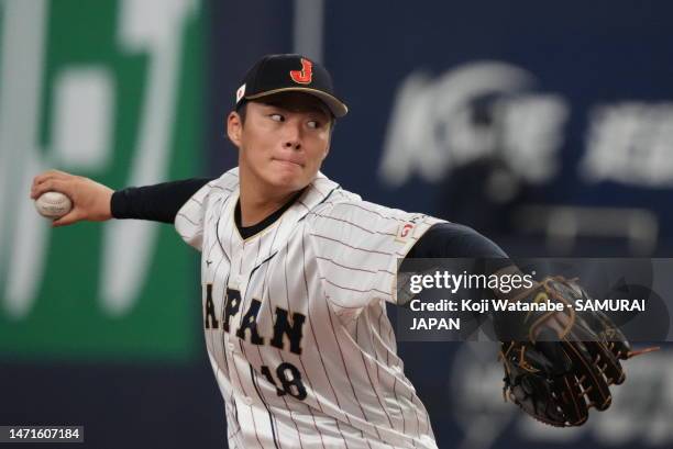 Pitcher Yoshinobu Yamamoto of Japan throws in the second inning during the World Baseball Classic exhibition game between Japan and Hanshin Tigers at...