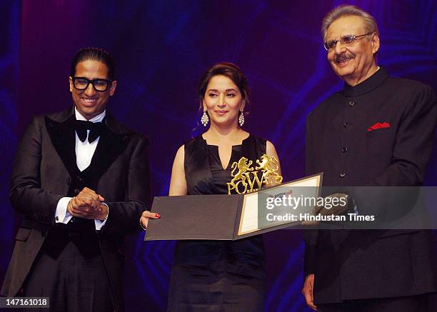 Chairman YC Deveshwar honors actress Madhuri Dixit as IIPM director Arindam Chaudhuri looks on at the Power Brands Awards in sector-29, Kingdom of...