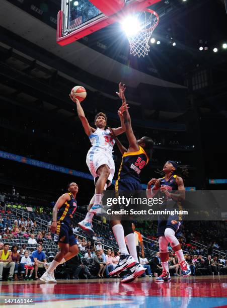 Angel McCoughtry of the Atlanta Dream puts up a shot against Jessica Davenport of the Indiana Fever at Philips Arena on June 26, 2012 in Atlanta,...