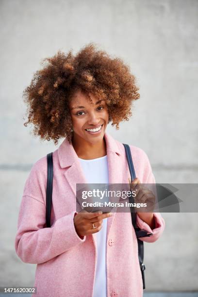 happy woman text messaging through smart phone - business smartphone happy spring fotografías e imágenes de stock