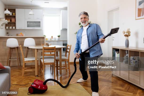 dancing with vacuum cleaner - housework humour stock pictures, royalty-free photos & images