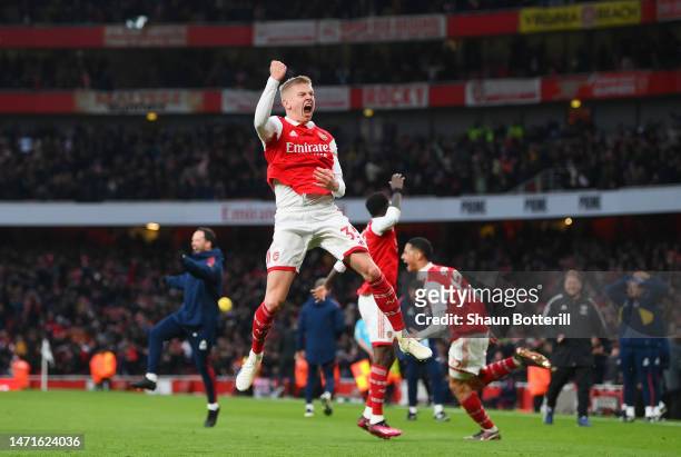 Oleksandr Zinchenko of Arsenal celebrates the team's third goal, scored by teammate Reiss Nelson during the Premier League match between Arsenal FC...