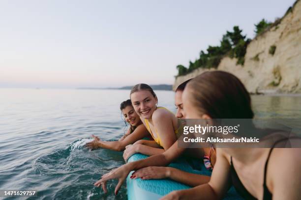 suping on the beach - young women group stock pictures, royalty-free photos & images