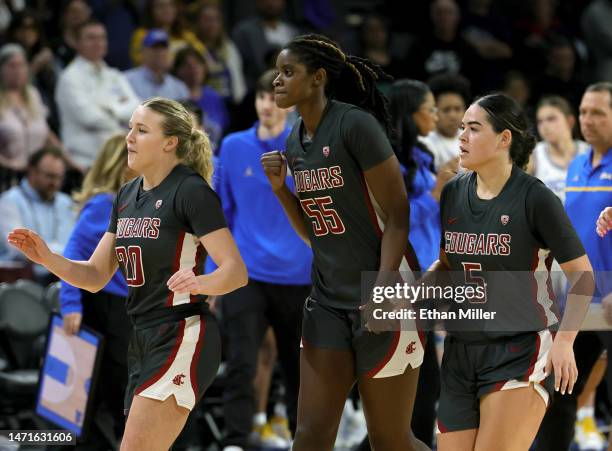 Grace Sarver, Bella Murekatete and Charlisse Leger-Walker of the Washington State Cougars run off the court for a timeout in the second half of the...