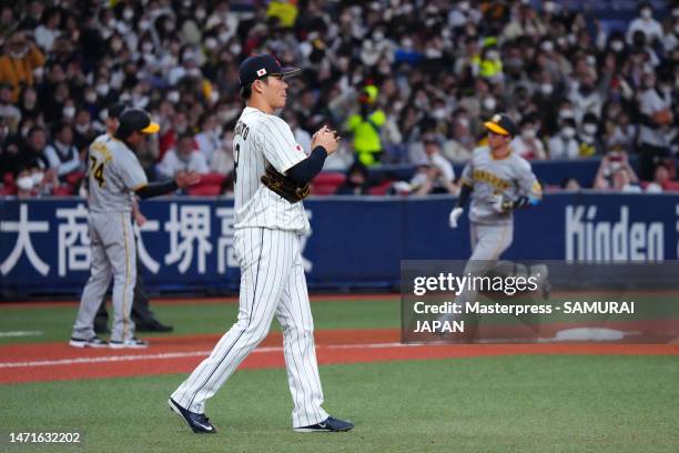 Pitcher Yoshinobu Yamamoto of Japan reacts after allowing Koji Chikamoto of Hanshin Tigers a solo home run in the third inning during the World...