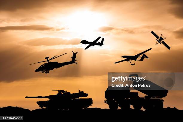 arms race. armored tanks, combat drone and missile launcher at sunset. - oorlog stockfoto's en -beelden
