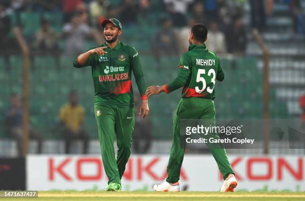 Bangladesh bowler Mehidy Hasan Miraz celebrates with Shakib Al Hasan after taking the wicket of Sam Curran during the 3rd ODI between Bangladesh and...