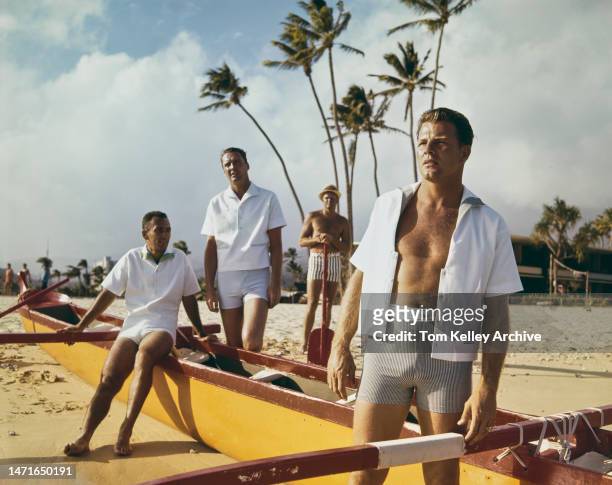 American sporting figures in Hawaii, 1962. Left to right: basketball players Bob Cousy and Bud Palmer , skiing filmmaker Warren Miller and American...
