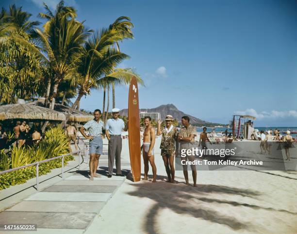 American sporting figures at Waikiki Beach, Honolulu, Hawaii, 1962. Left to right: basketball player Bob Cousy, golfer Ken Venturi , American...